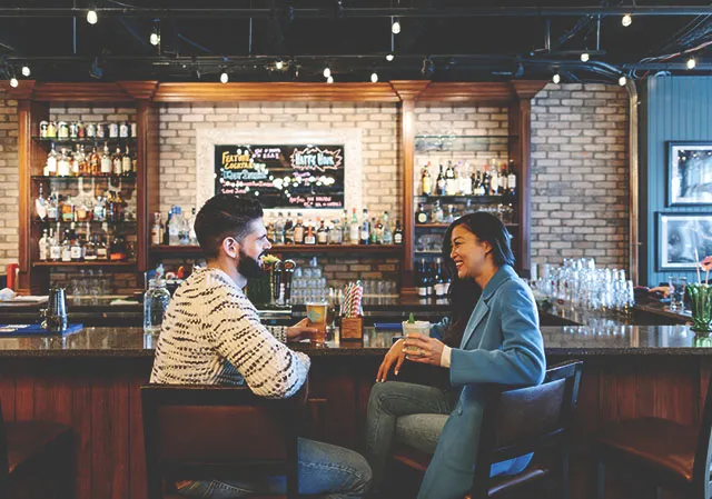 A couple sits at the bar of the King Eddy