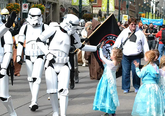 a stormtrooper high fives a young Elsa during the POW Parade of Wonders