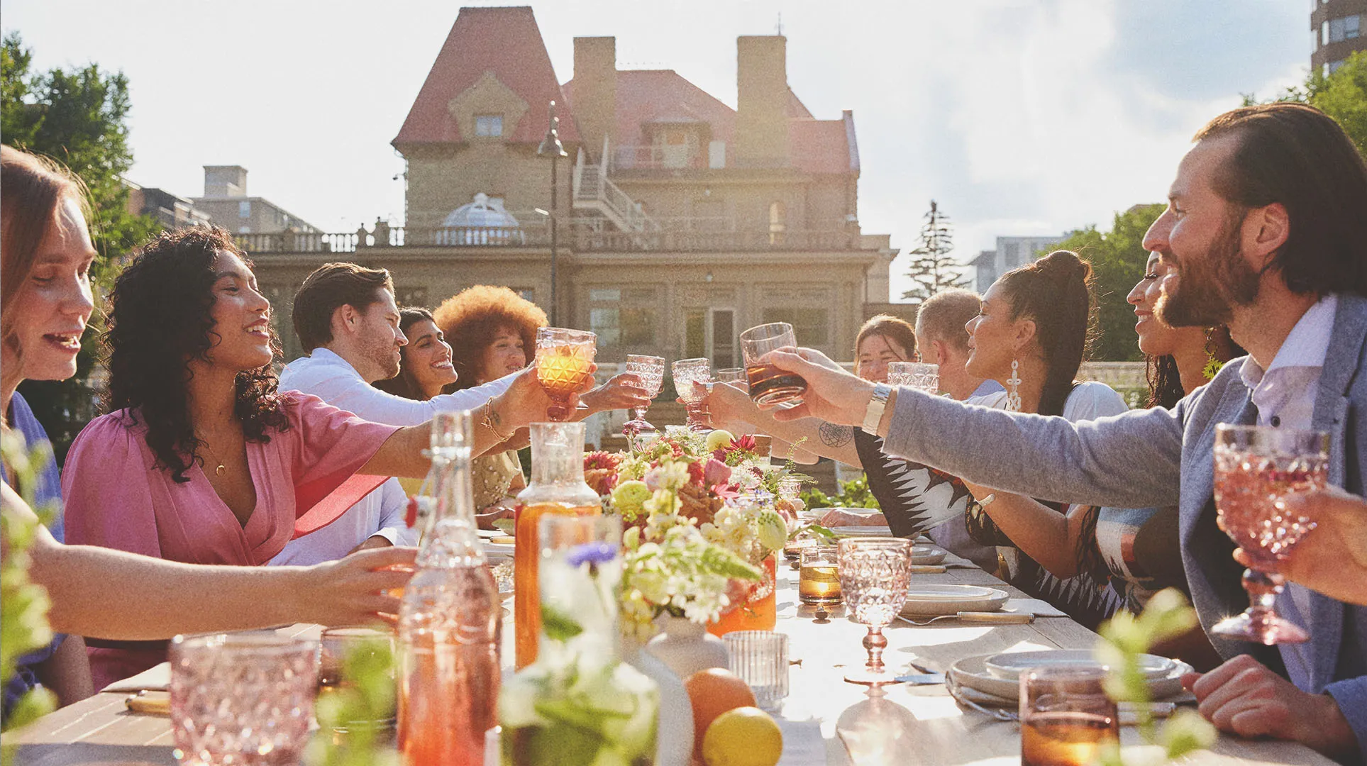 group dining at a long table during a private event held at Lougheed House during spring