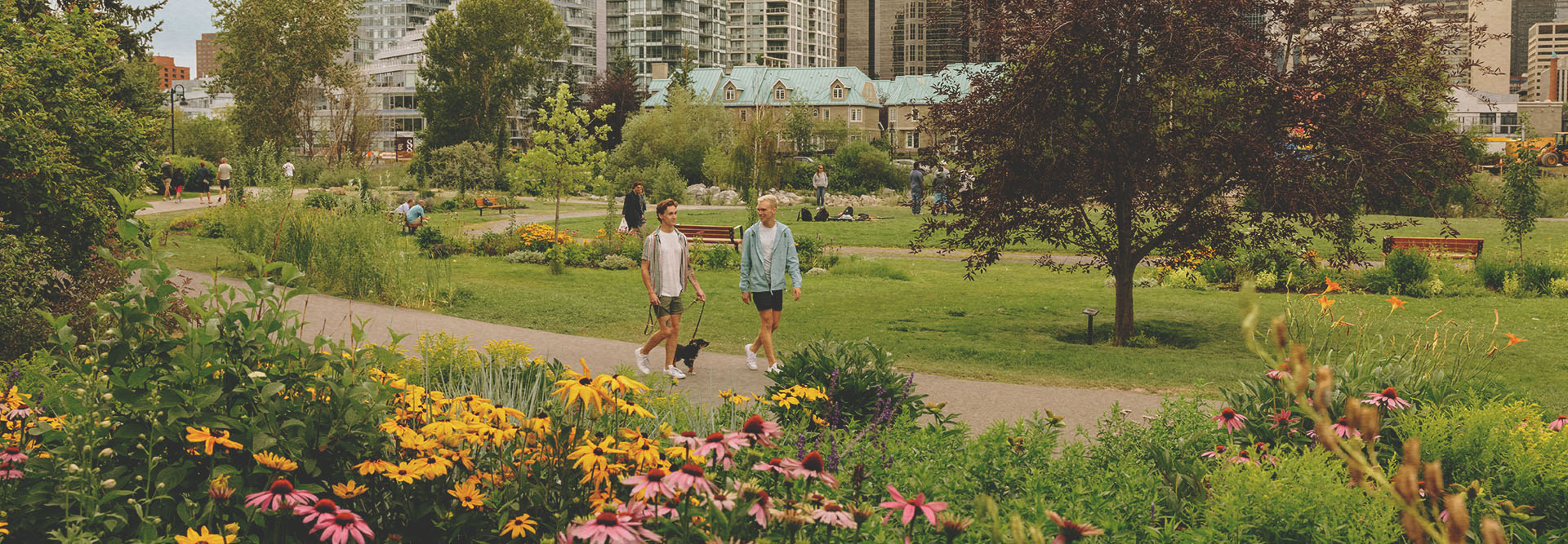 Couple walking through Prince's Island Park in spring