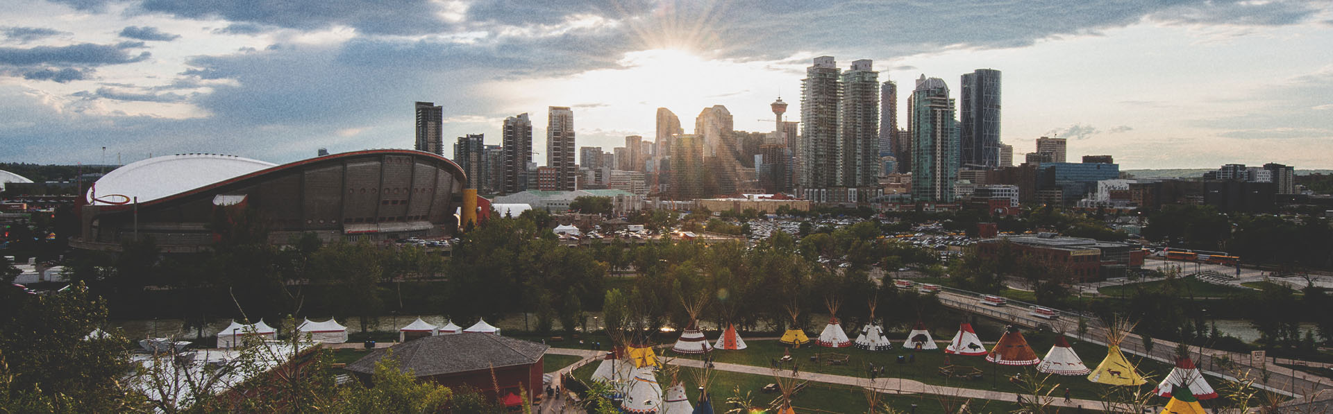 Elbow River Camp at Calgary Stampede with the Calgary skyline in the background
