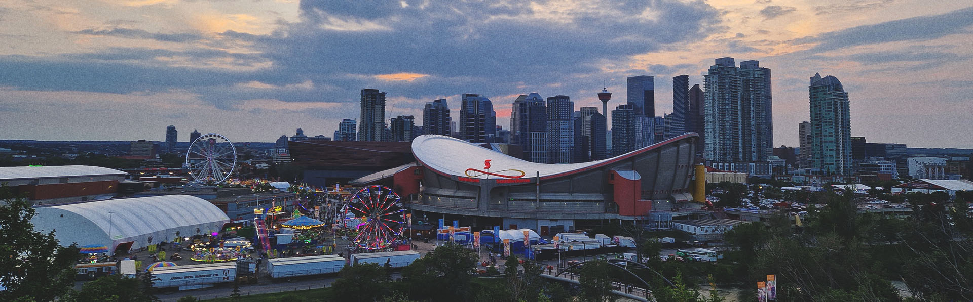 the Stampede Grounds with the Calgary skyline in the background at dusk