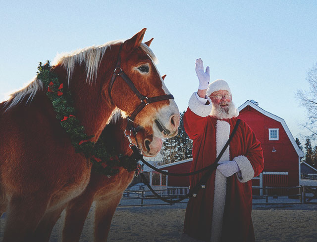 Santa is with horses at Heritage Park in Calgary