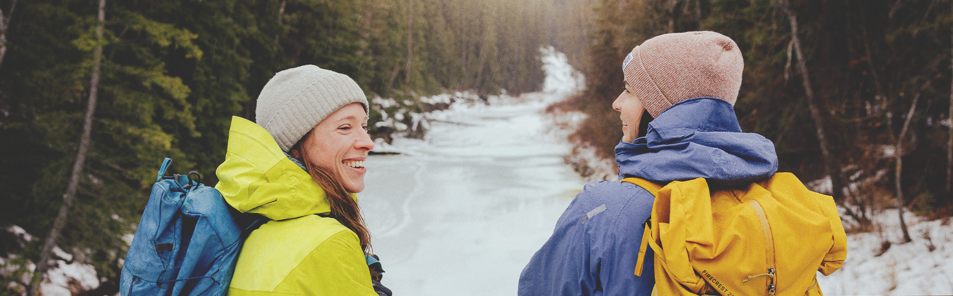 couple takes a break from a winter hike in Fish Creek Park