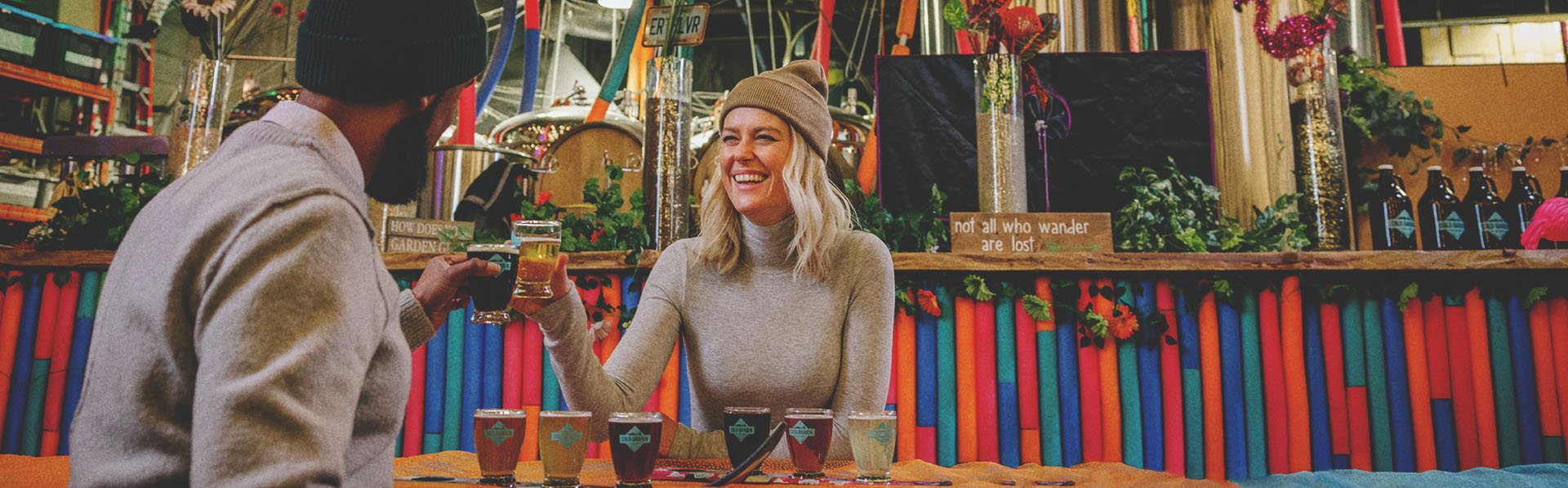 A smiling couple toasting with beer glasses