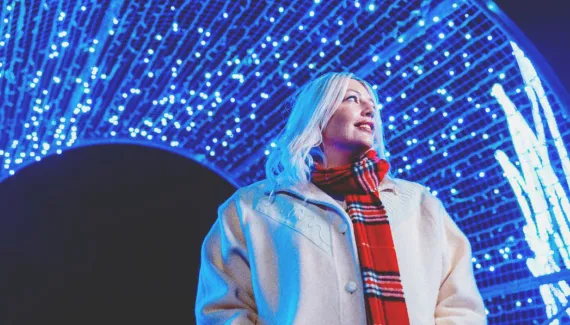 woman exploring the holiday light displays at ZOOLIGHTS