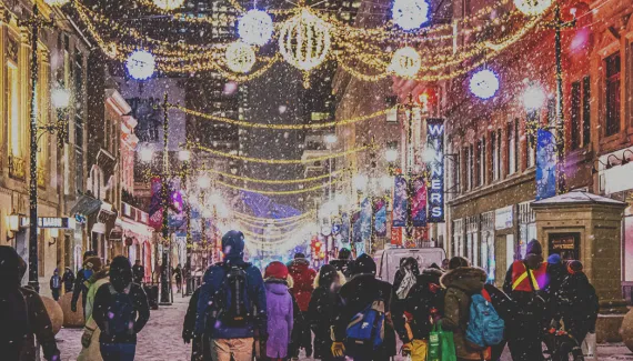 crowd exploring the Chinook Blast installations along Stephen Avenue during snowfall