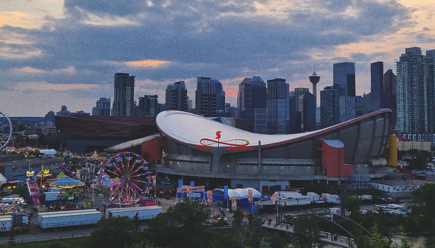 the Stampede Grounds with the Calgary skyline in the background at dusk