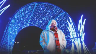 woman exploring the holiday light displays at ZOOLIGHTS