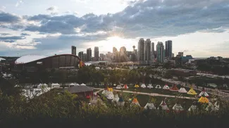 Elbow River Camp at Calgary Stampede with the Calgary skyline in the background