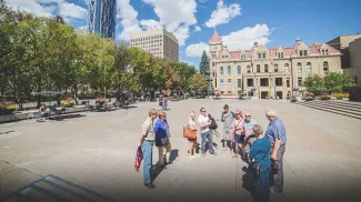A group on a guided walking tour throughout downtown Calgary