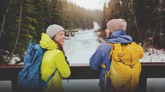 couple takes a break from a winter hike in Fish Creek Park