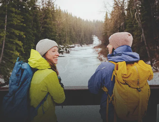 couple takes a break from a winter hike in Fish Creek Park