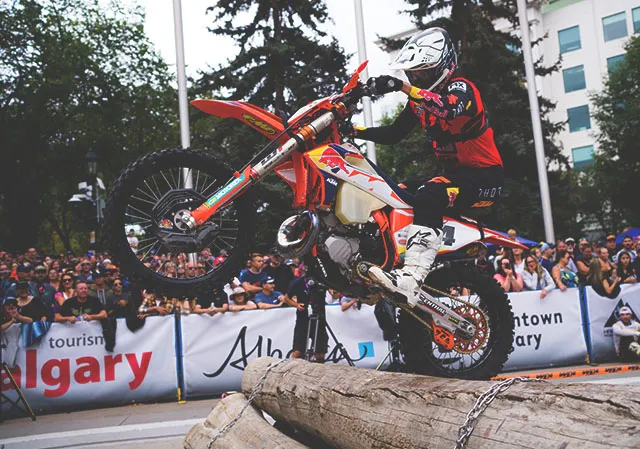 motocross biker racing over obstacles in Calgary's Olympic plaza