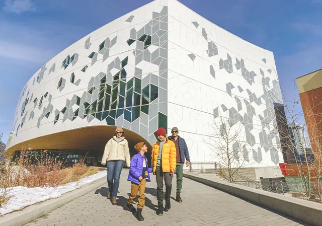 family walking in front of Calgary's central library