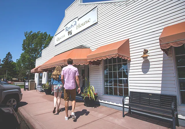 two people walk into the Rosebud Theatre Opera House during summer