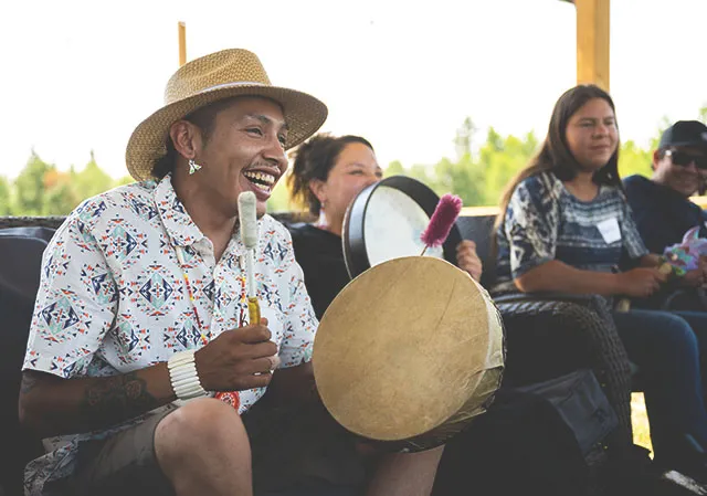 Indigenous person traditional drumming at Dodging Horse Ranch