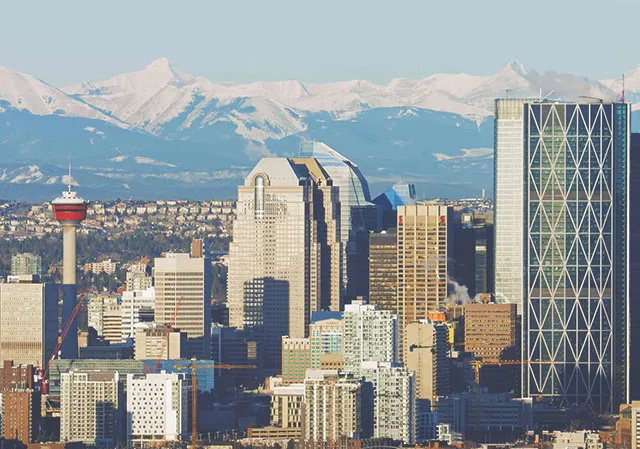 The Rocky Mountains rise above the Calgary skyline
