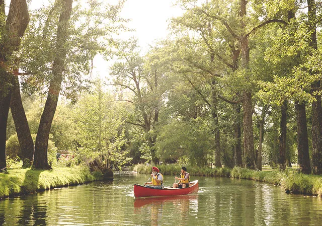 father &amp; son canoeing in bowness lagoon