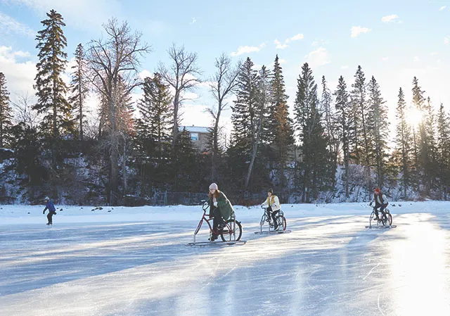 group of friends ice biking on Bowness lagoon during winter