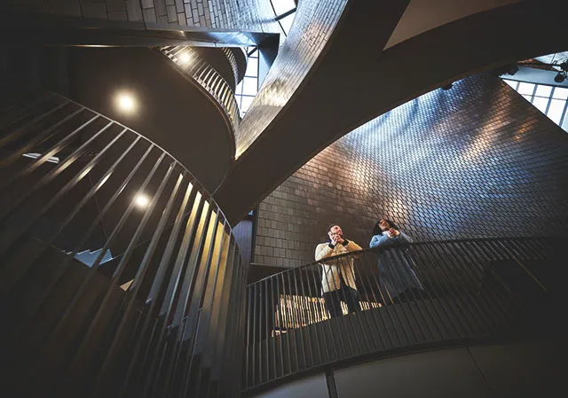 couple admires the interior architecture of Studio Bell