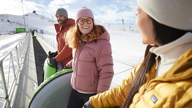 group of friends tubing at Winsports tube park during winter
