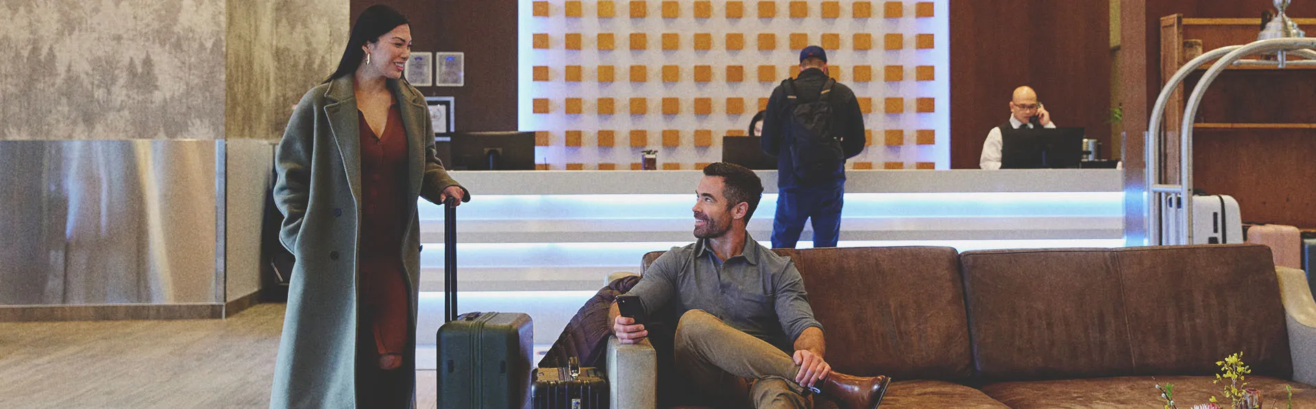 two people greet each other in the lobby of a Calgary Hotel