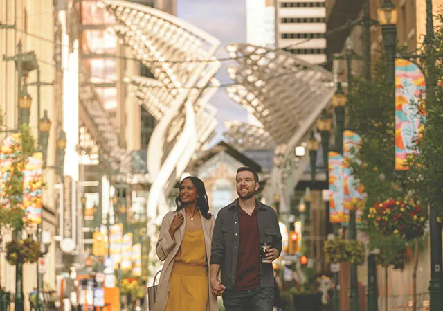 a couple walks along Stephen Avenue in downtown Calgary