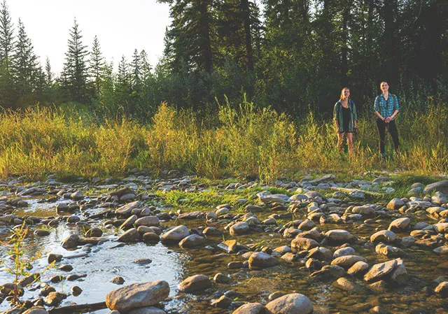 friends hiking through Fish Creek Park near a creek