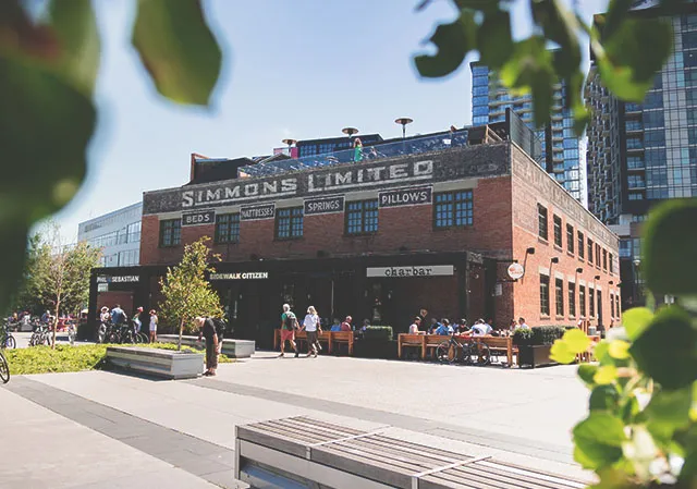 photograph of the outside of the Simmons building along the RiverWalk in Calgary