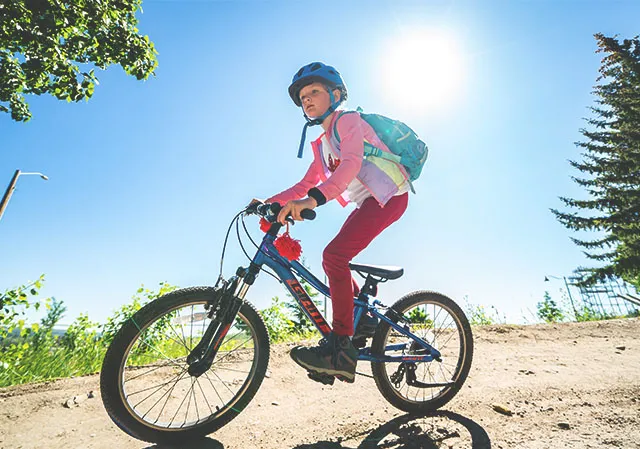 a kid is biking at Winsport bike park