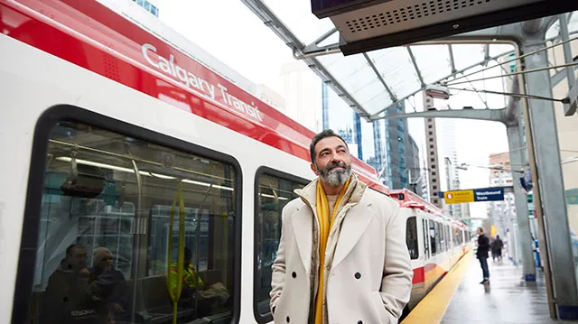 a man standing at the CTrain station