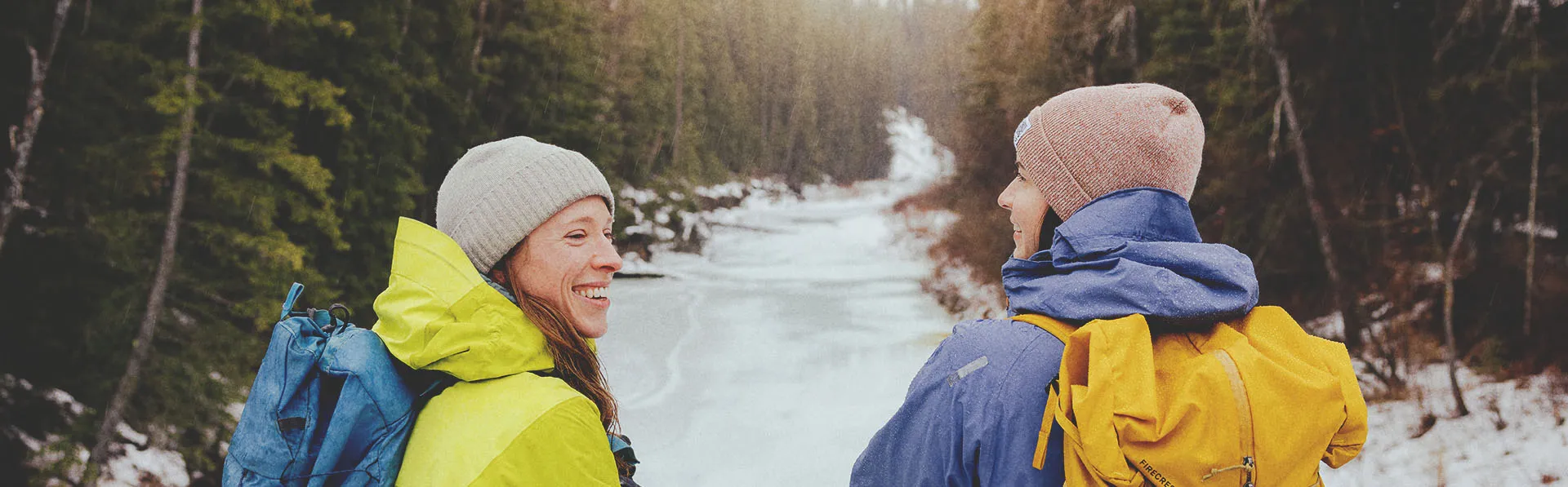 two people hiking through a creek in Fish Creek Provincial Park