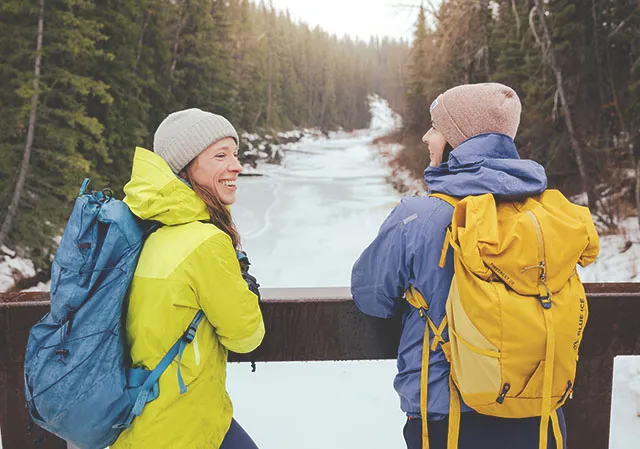 two women enjoying a winter hike in Fish Creek Park