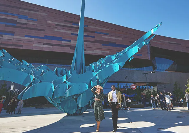 a couple walking in front of BMO Centre Calgary