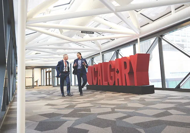 two men walking in the Telus Convention Centre