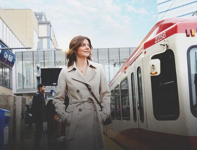 a lady is at CTrain station downtown Calgary