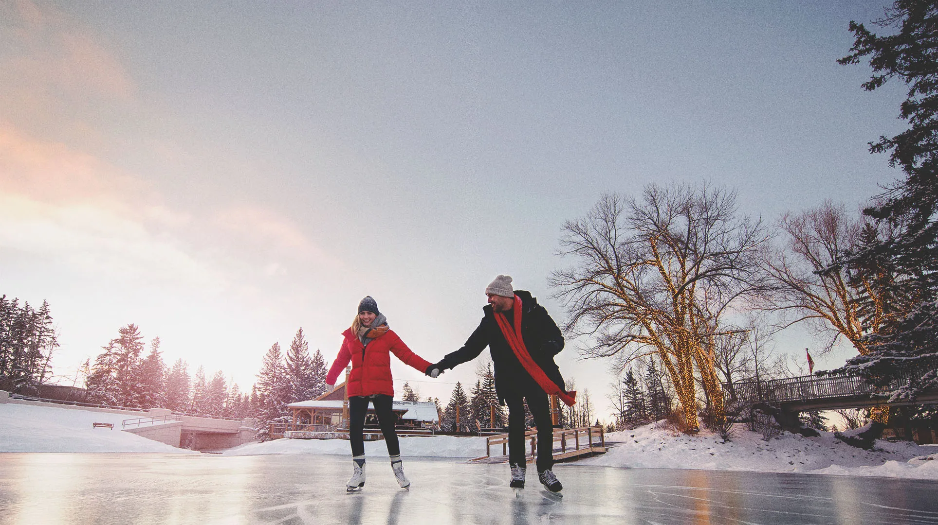 a couple skating at Bowness Park Lagoon 