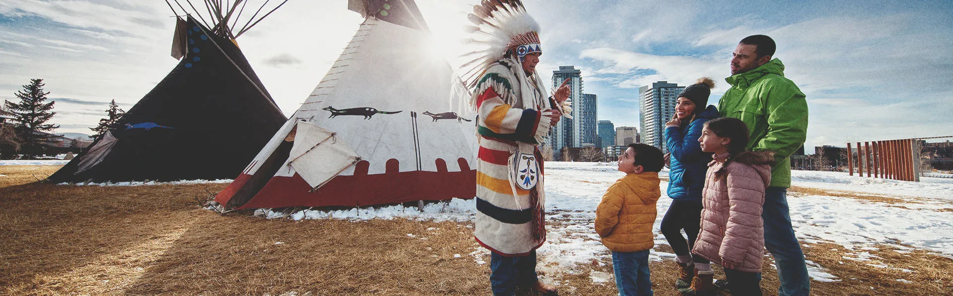 Indigenous representative guiding a family at The Confluence Calgary