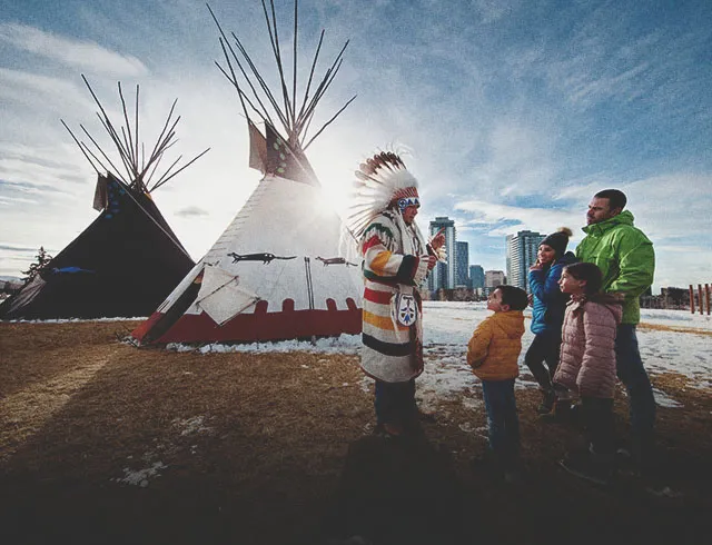 Indigenous representative guiding a family at The Confluence Calgary